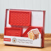 A King Arthur Baking Company 3-D Gingerbread Cutter Set sits on a wooden tabletop.