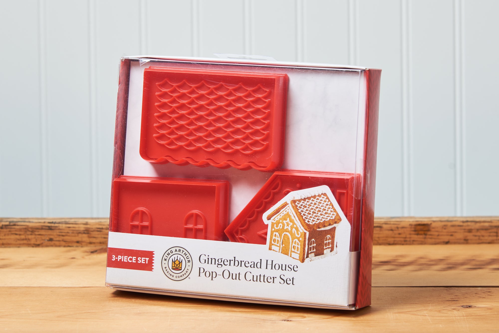 A King Arthur Baking Company 3-D Gingerbread Cutter Set sits on a wooden tabletop.