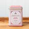 A tin of Harney & Sons English Breakfast tea sits on a wooden countertop.