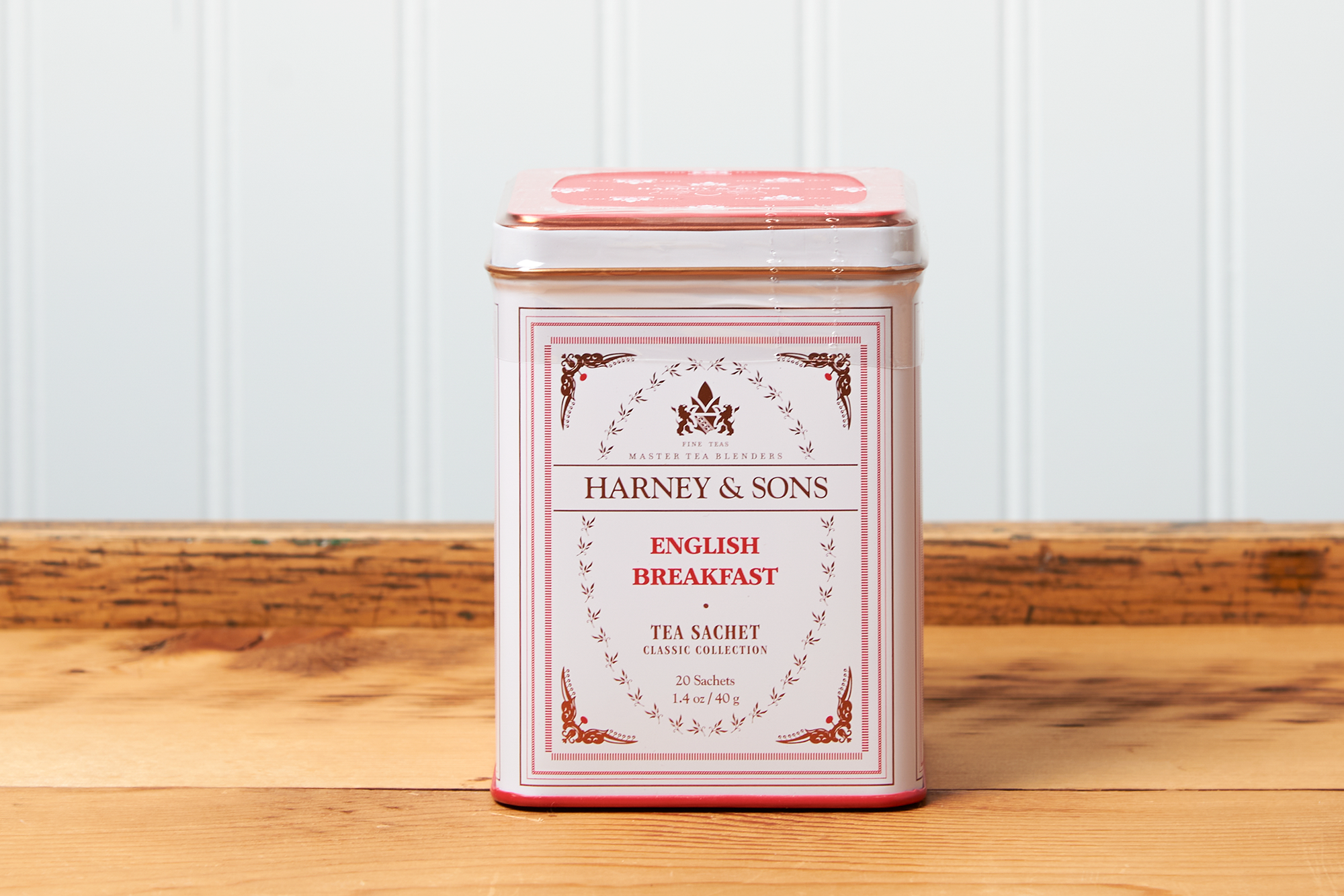 A tin of Harney & Sons English Breakfast tea sits on a wooden countertop.