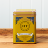 A tin of Harney & Sons Ginger Lemon tea sits on a wooden countertop.
