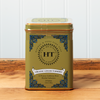 A tin of Harney & Sons Ginger Turmeric tea sits on a wooden countertop.