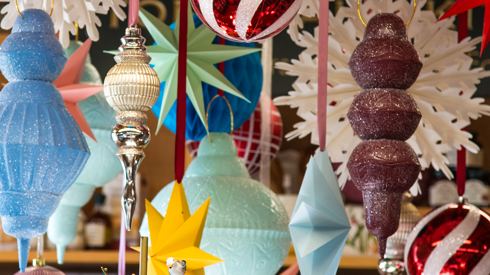 A close up shot of hanging ornaments in varied shapes, sizes, and colors.