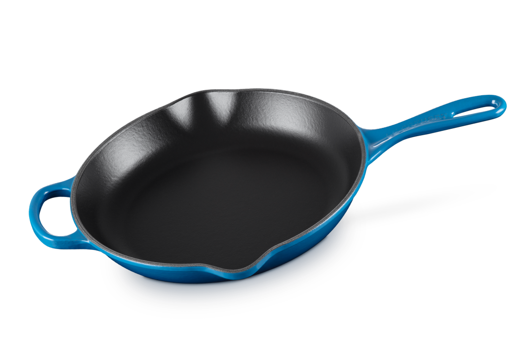 A Le Creuset 10.25 inch Signature Skillet in Marseille blue over a white background.