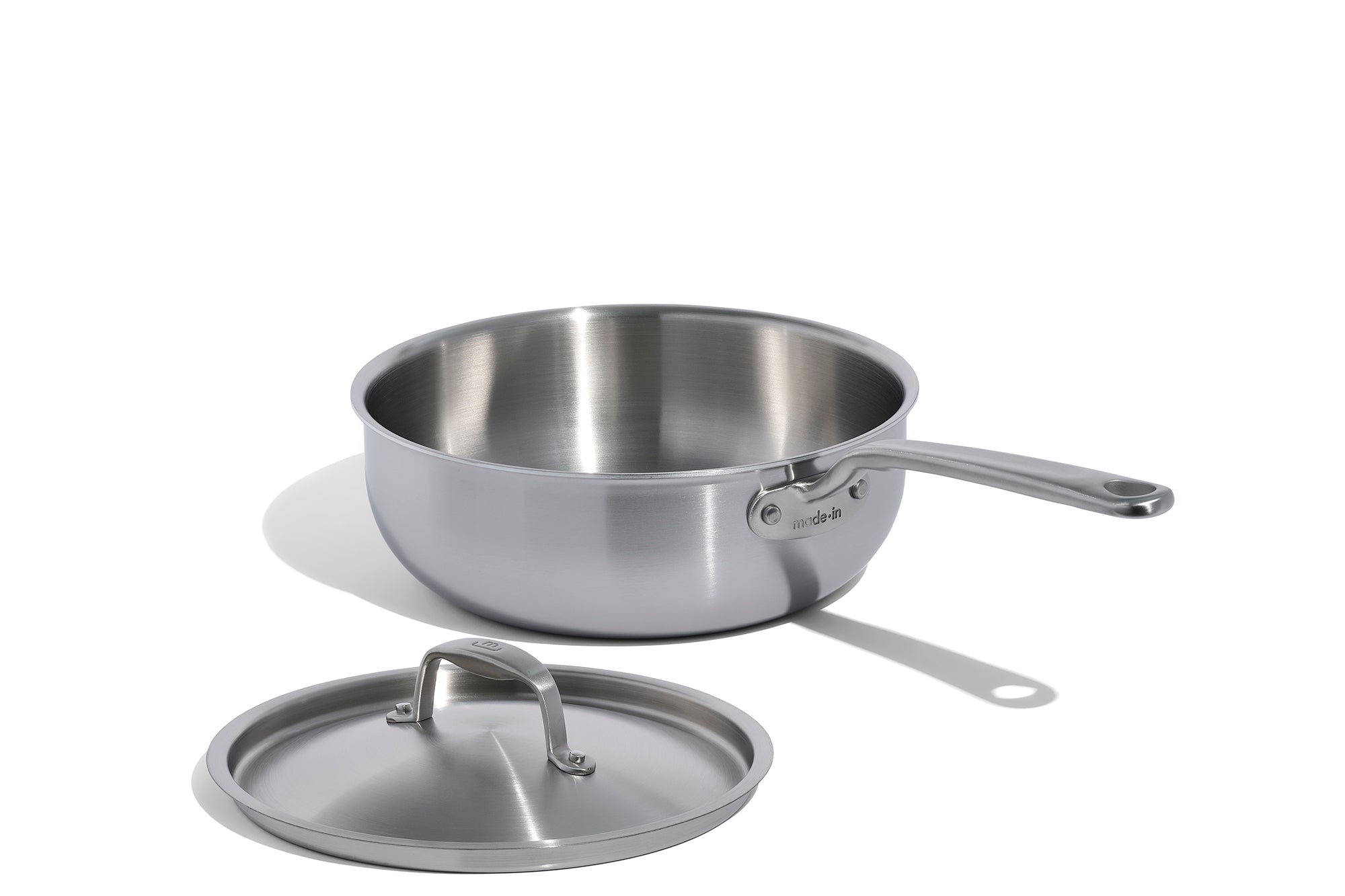 A Made In Stainless Clad Saucier with Lid in front of a white background.