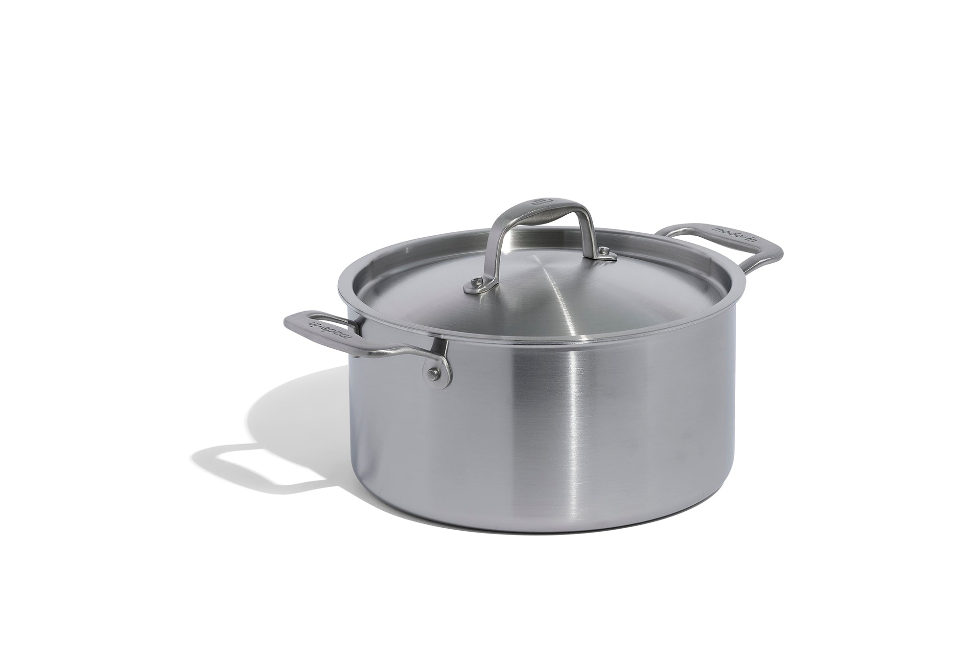 A Made In Stainless Clad Stock Pot in front of a white background.