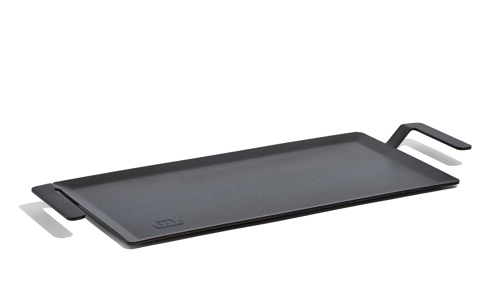A Made In Seasoned Carbon Steel Griddle in front of a white background.