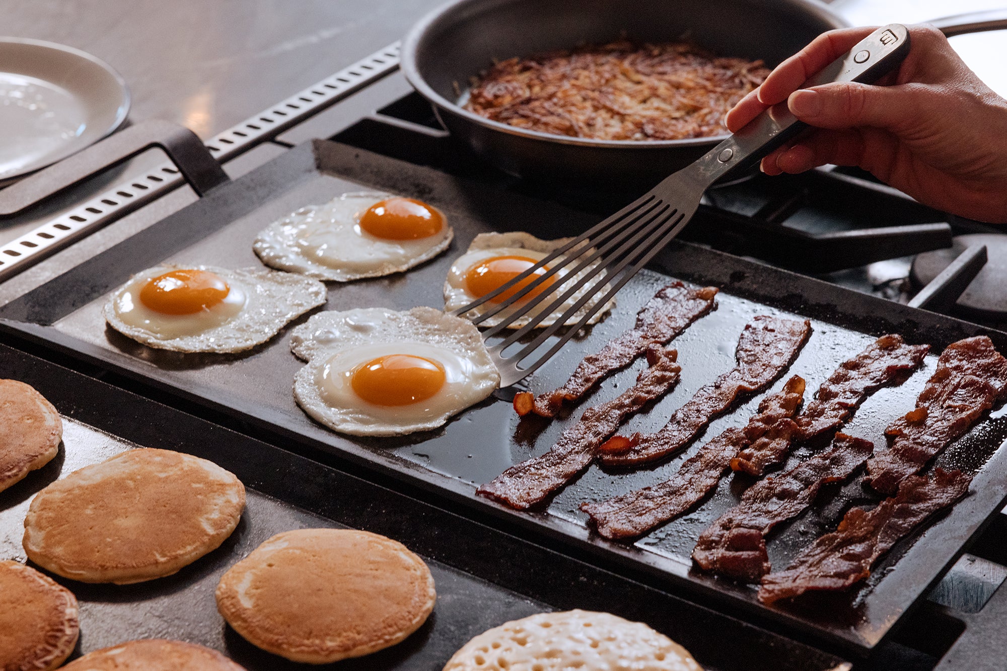 Bason, eggs, and pancakes are cooked on two Made In Seasoned Carbon Steel Griddles.