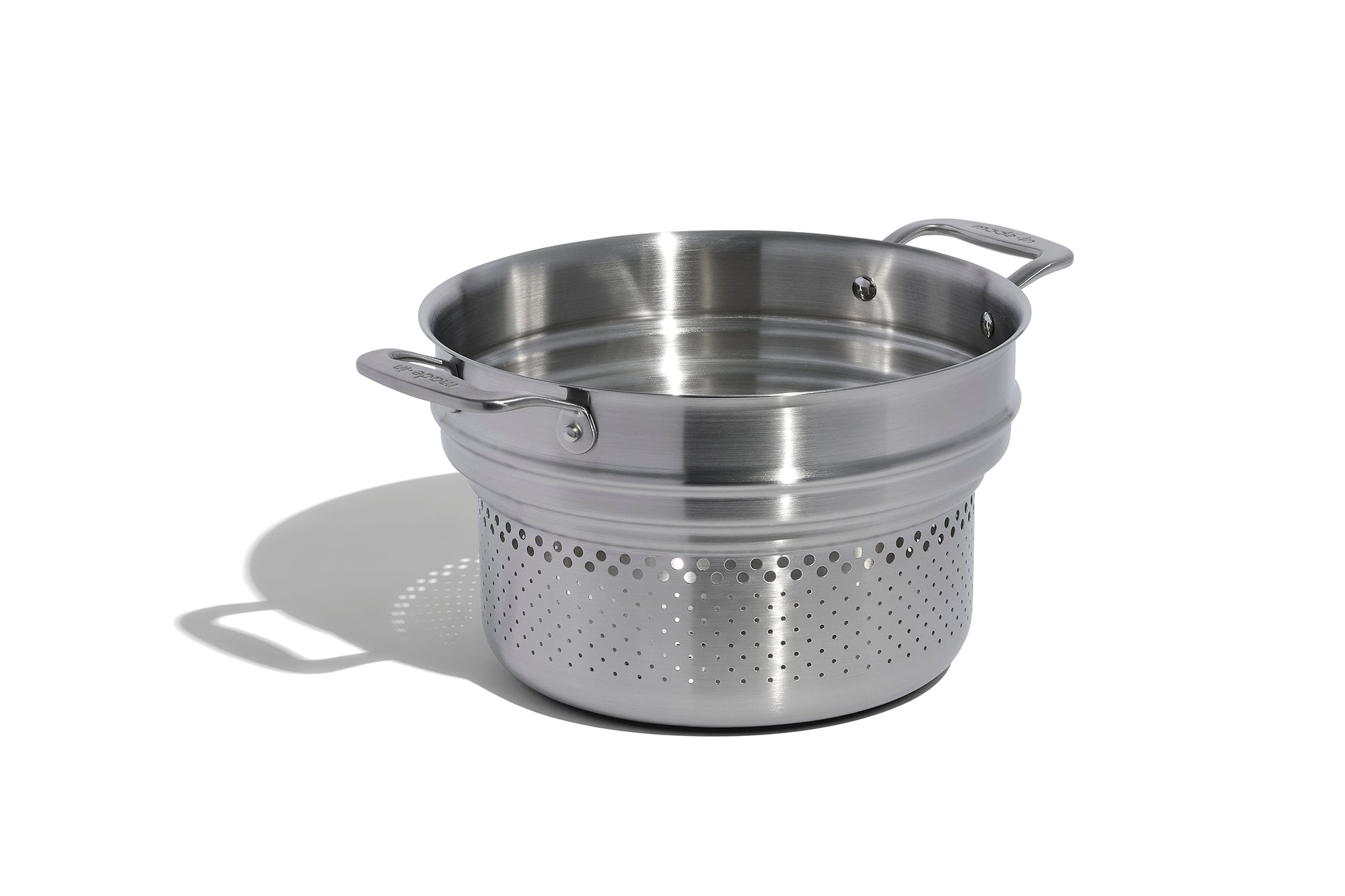 A Made In Stainless Clad Pasta Insert in front of a white background.