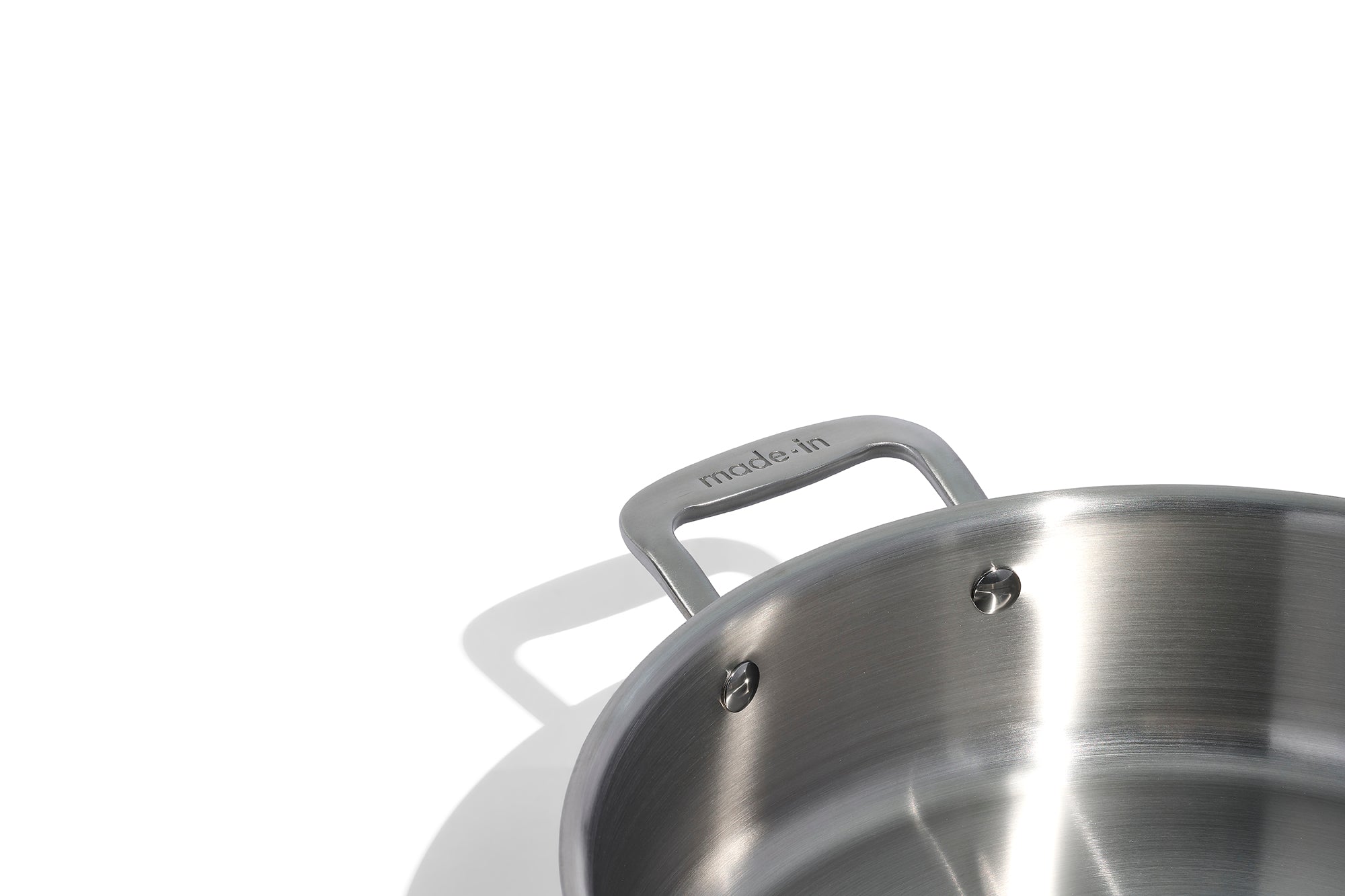 A close up of a Made In Stainless Clad Rondeau with Lid in front of a white background.