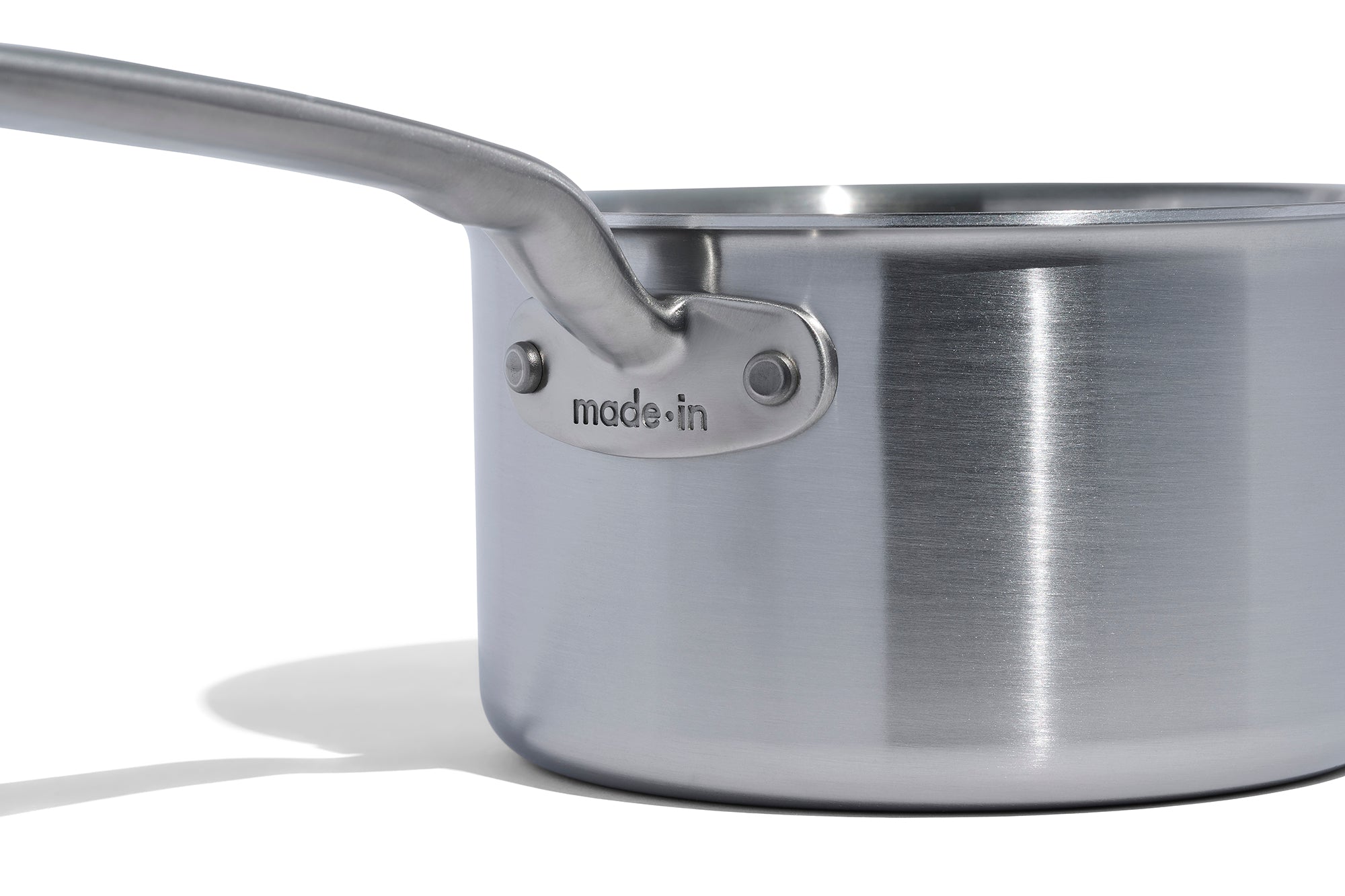 A close up of a Made In Stainless Clad Saucepan in front of a white background.