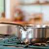 A Made In Stainless Clad Saucier sits on a stovetop.