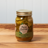 A jar of Maine Homestead Bread and Butter Pickles sits on a brown wooden table.