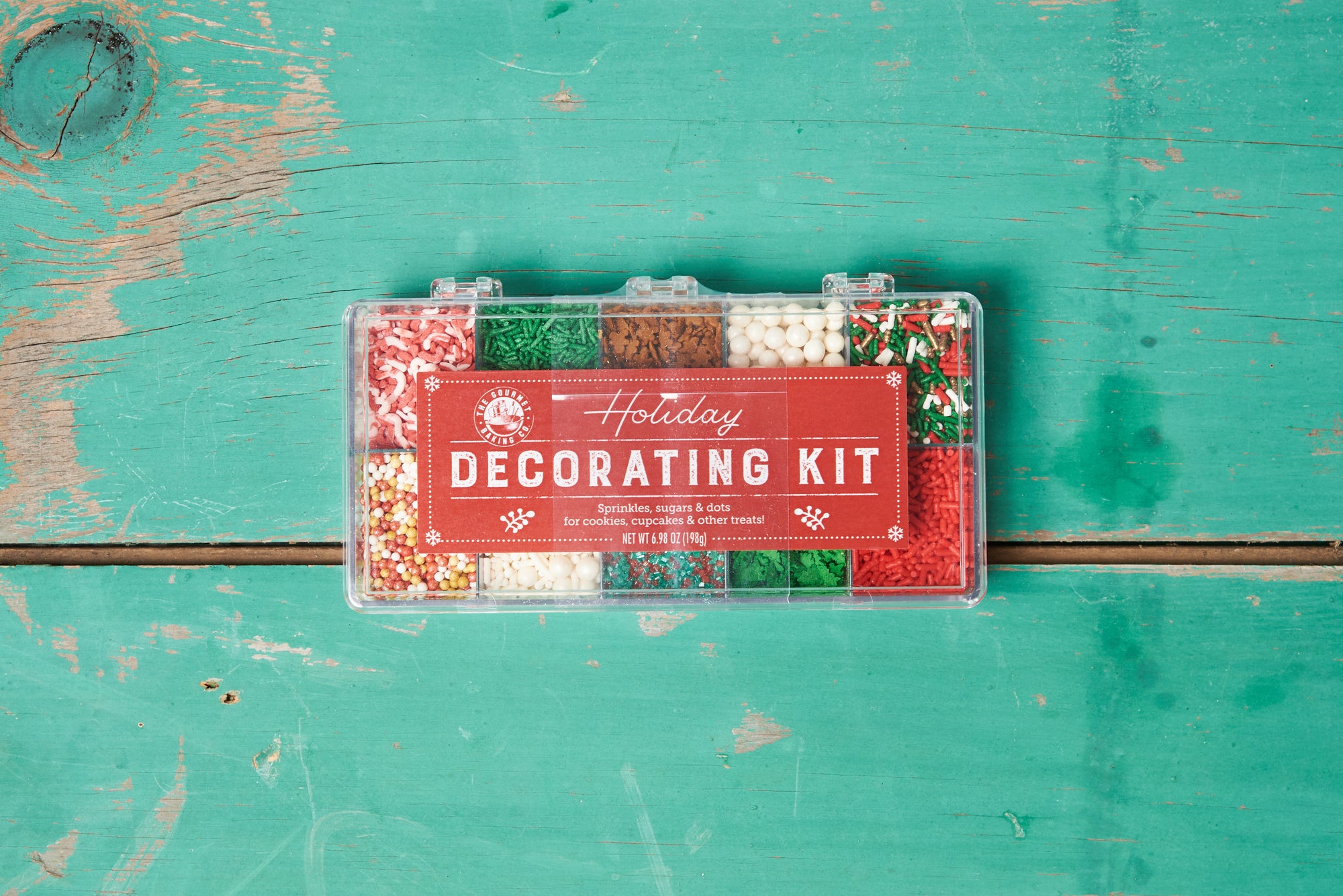 A Pepper Creek Farms	Holiday Decorating Kit on a turquoise tabletop.