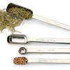 An RSVP Endurance Spice Measuring Spoons, Set of 6 over a white background with spices.