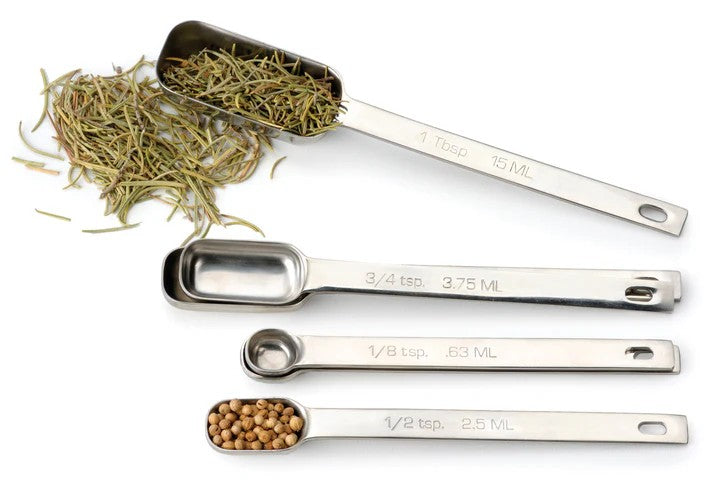An RSVP Endurance Spice Measuring Spoons, Set of 6 over a white background with spices.