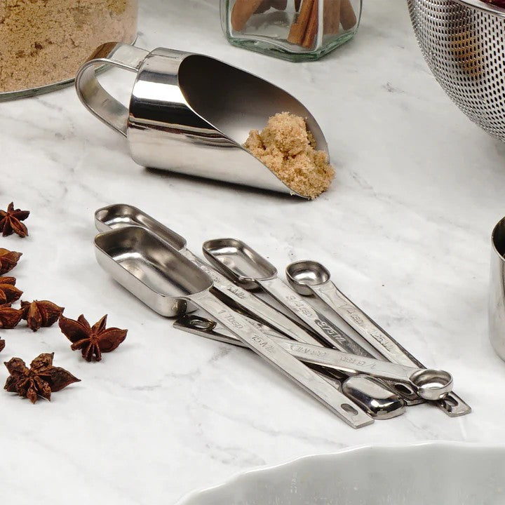 An RSVP Endurance Spice Measuring Spoons, Set of 6 on a marble countertop.