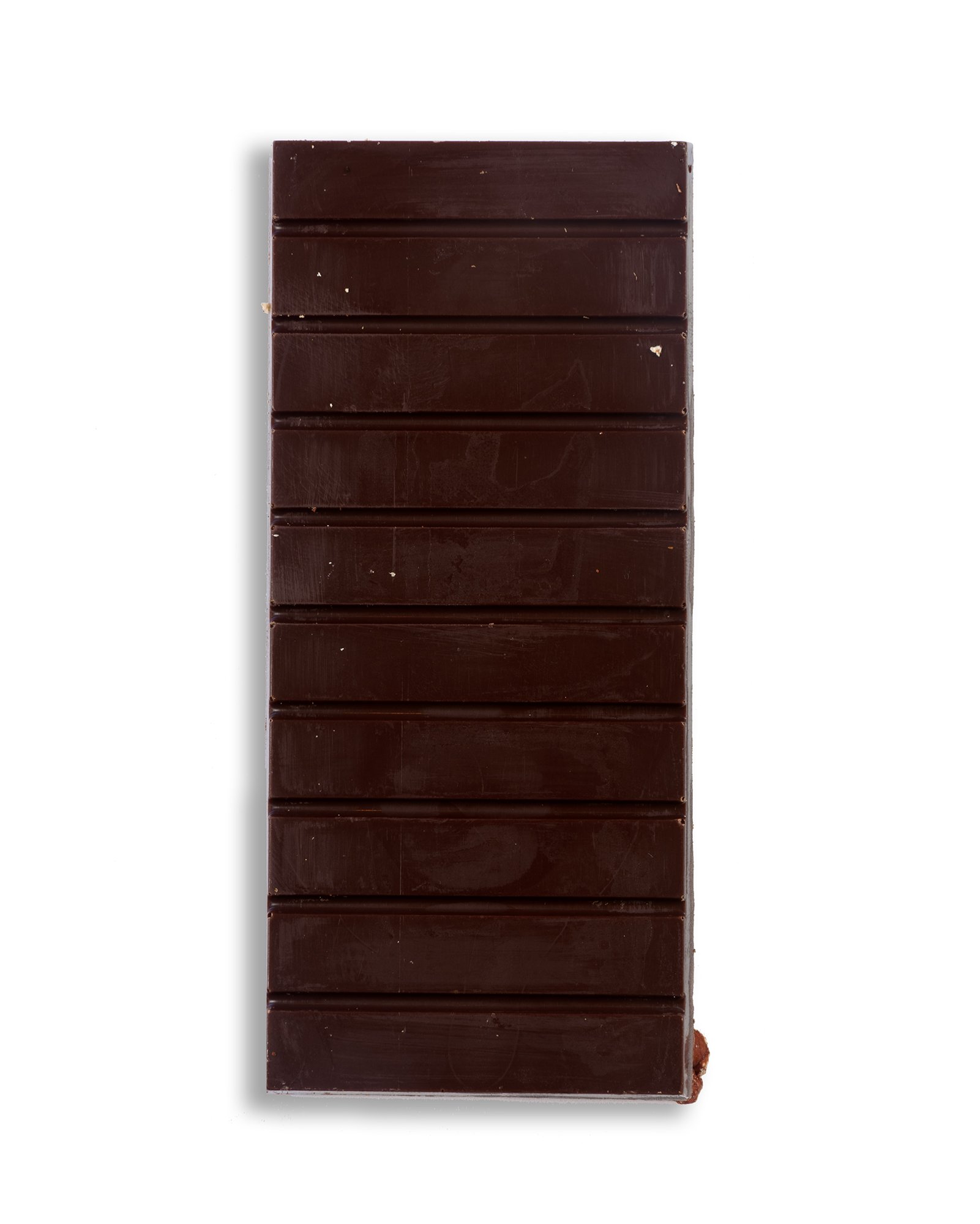 A close up shot of a Ragged Coast Chocolate Bark Ancho Chile and Roasted Pecan bar on a white background.