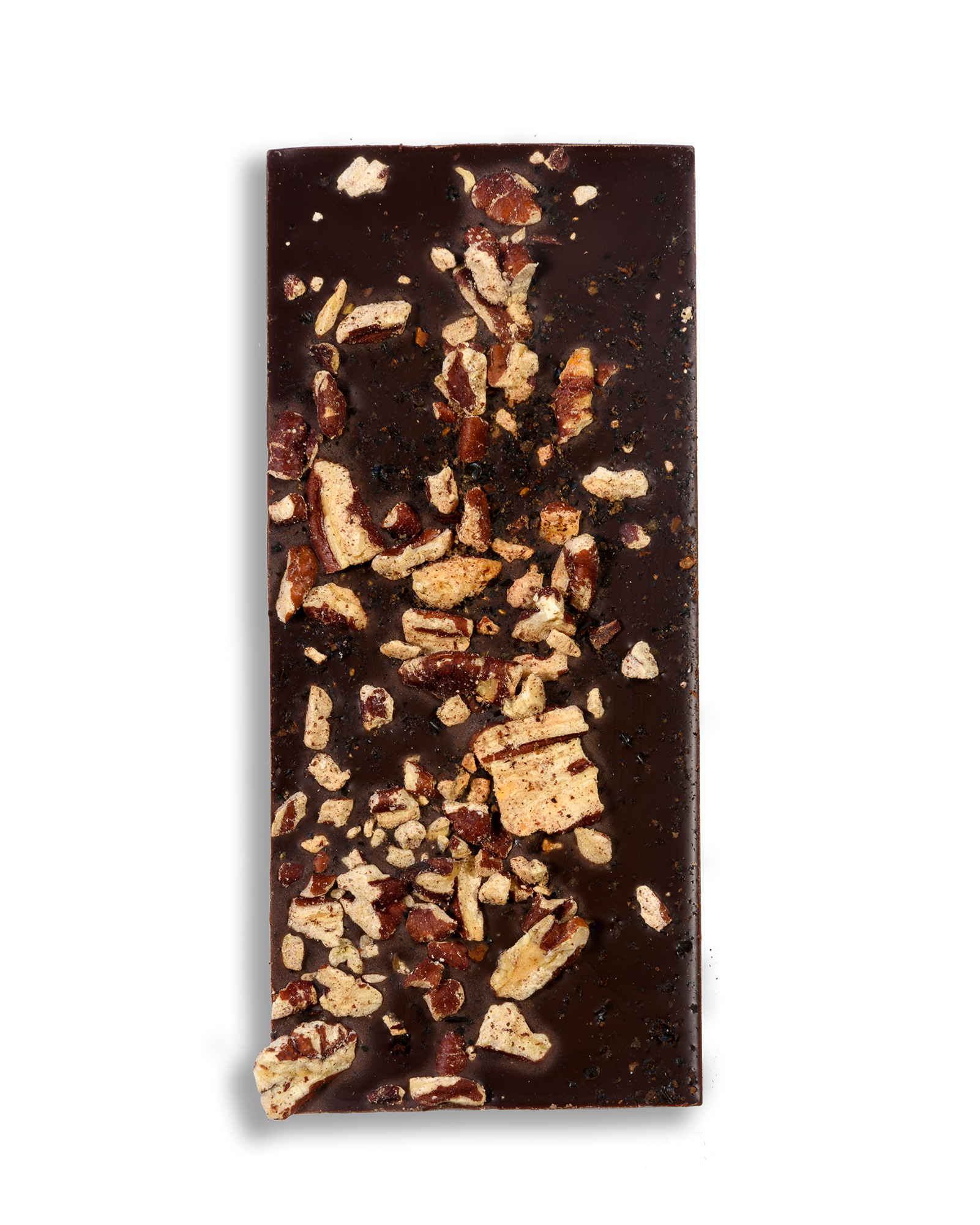 A close up shot of a Ragged Coast Chocolate Bark Ancho Chile and Roasted Pecan bar on a white background.