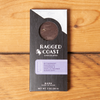 One Ragged Coast Chocolates Chocolate Lavender Blossom Bark sits on a wooden table.
