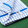 A blue Samuel Lamont Poli-Dry Towel sits on a green wooden tabletop.