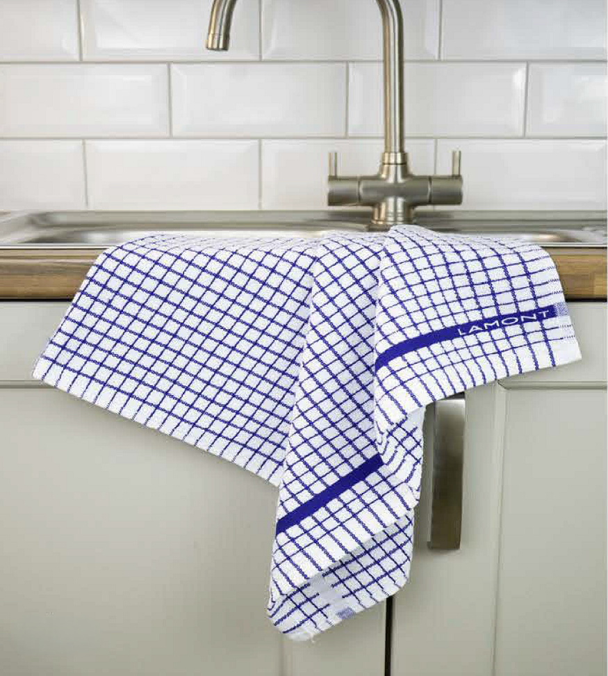 A blue Samuel Lamont	Poli-Dry Towel hangs over a sink.