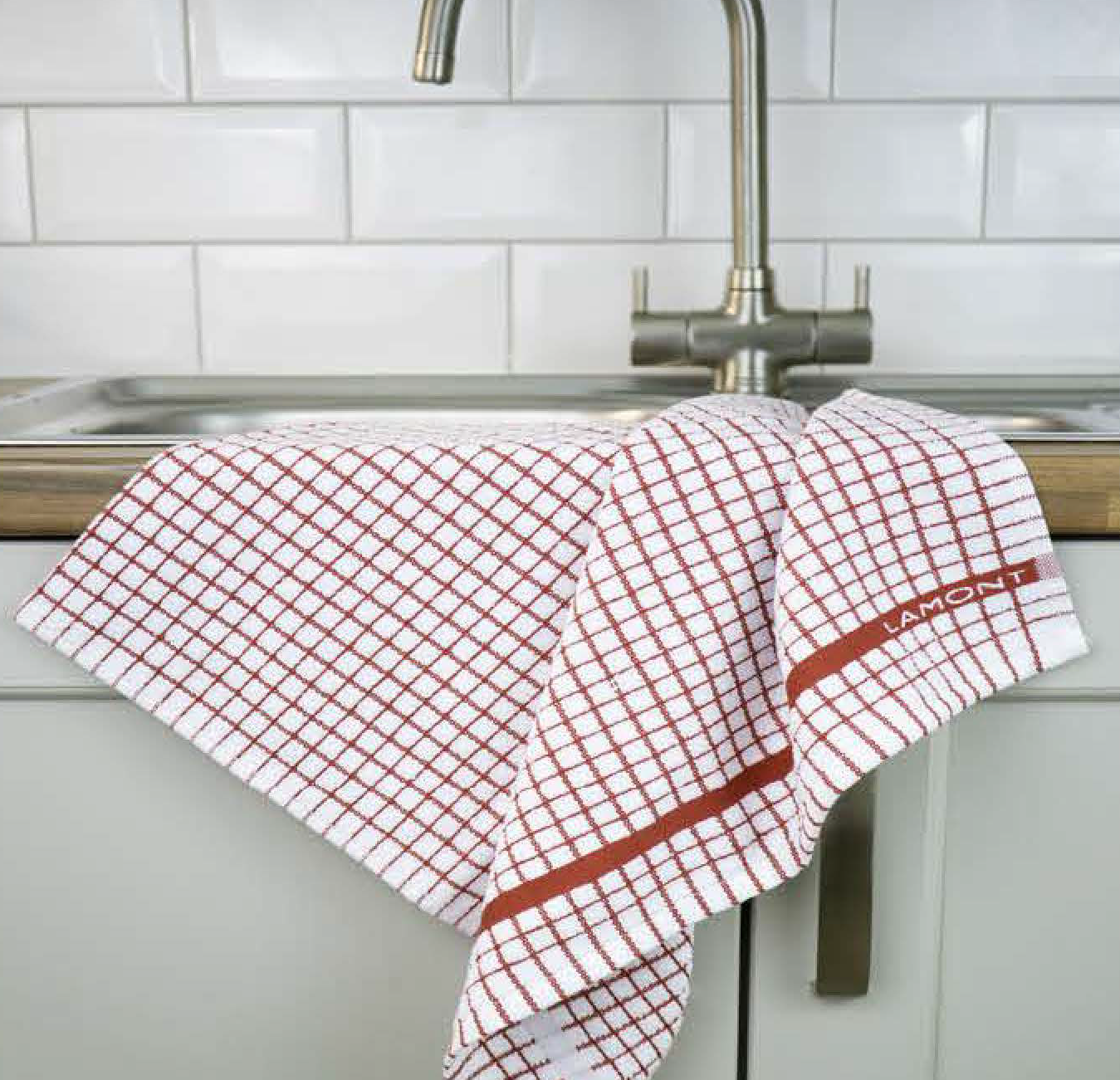 A red Samuel Lamont Poli-Dry Towel hangs over a sink.