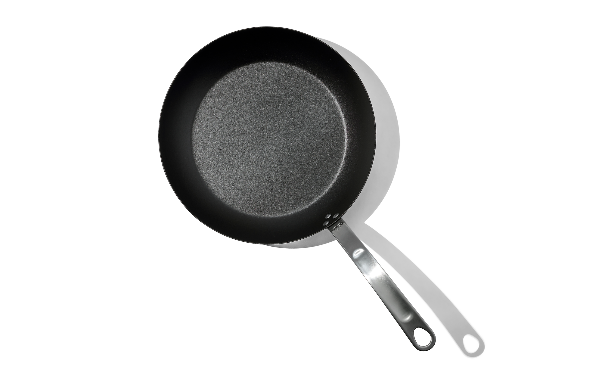 An overhead shot of a 12 inch Made In Seasoned Carbon Steel Fry Pan over a white background.