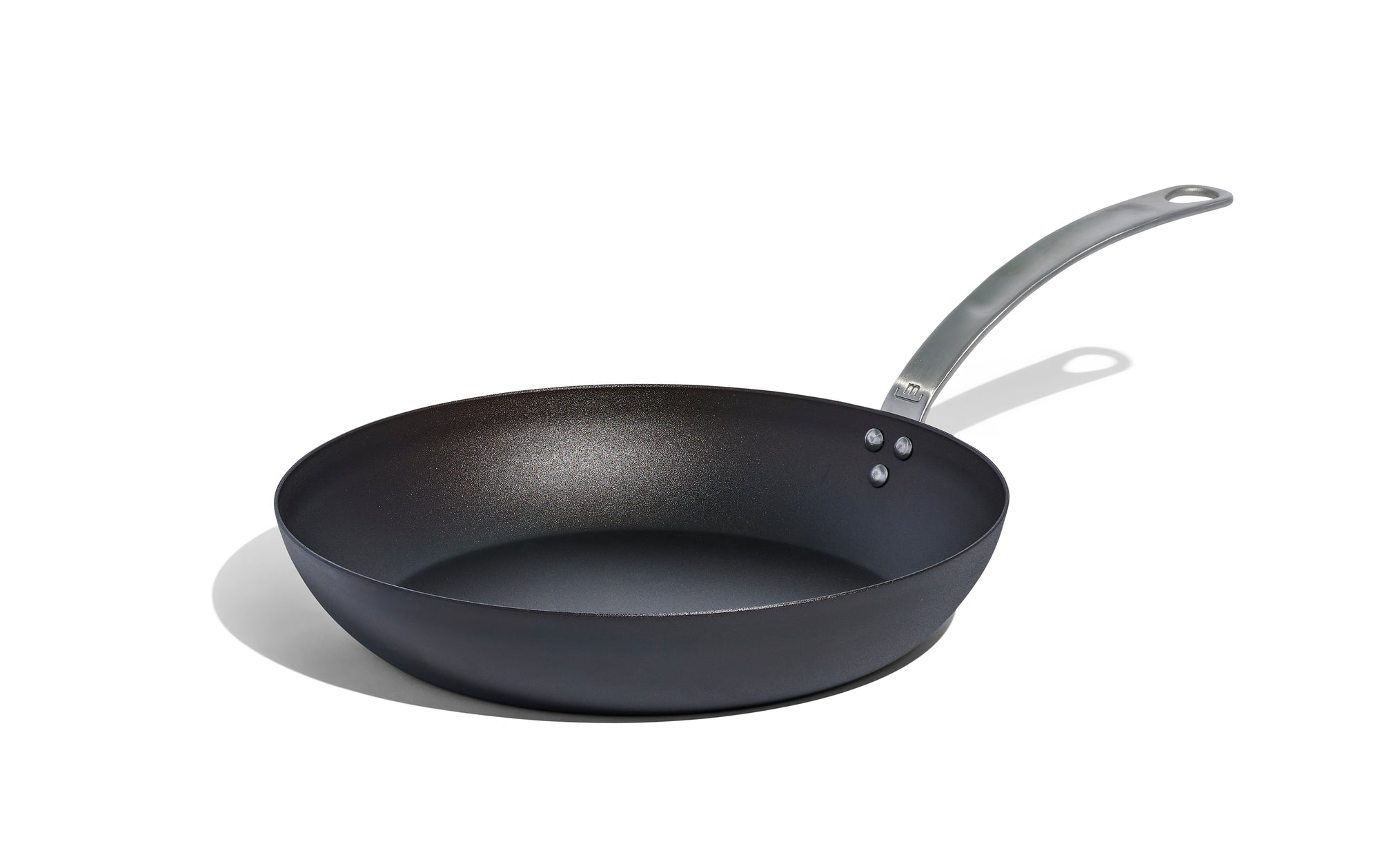 A Made In Seasoned Carbon Steel Fry Pan sits over a white background.