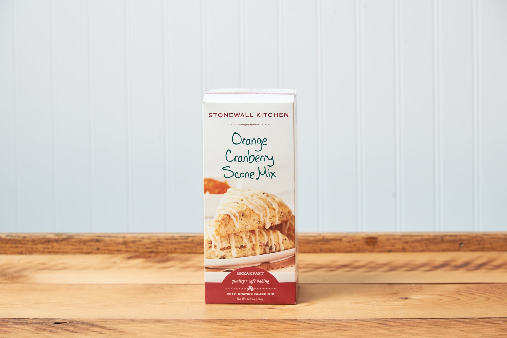 Stonewall Kitchen Orange Cranberry Scone Baking Mix sits on a wooden tabletop.