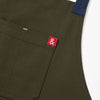 A close up shot of a Hedley & Bennett Olive Crossback Apron.