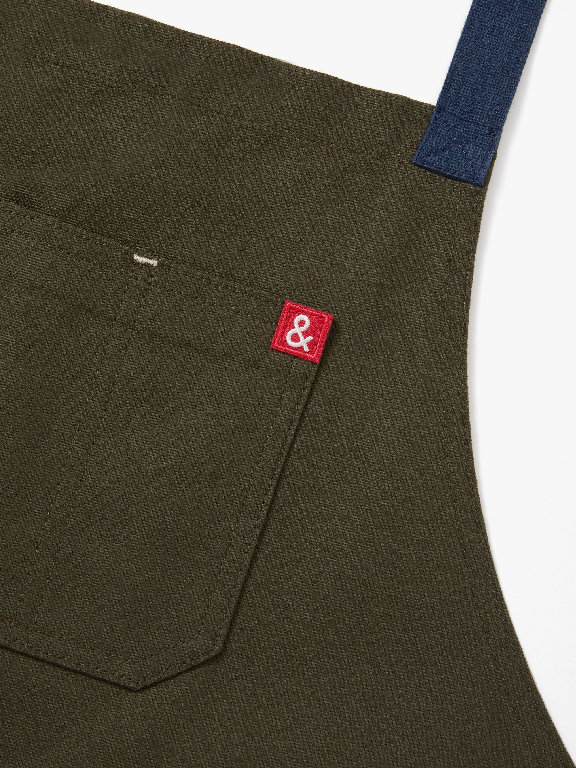A close up shot of a Hedley & Bennett Olive Crossback Apron.
