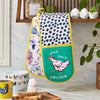 An Ulster Weavers Double Oven Mitt in the Chick Chicken pattern hangs over a kitchen countertop.