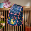 An Ulster Weavers Double Oven Mitt in the Marmalade Meadow pattern hangs over a kitchen countertop.