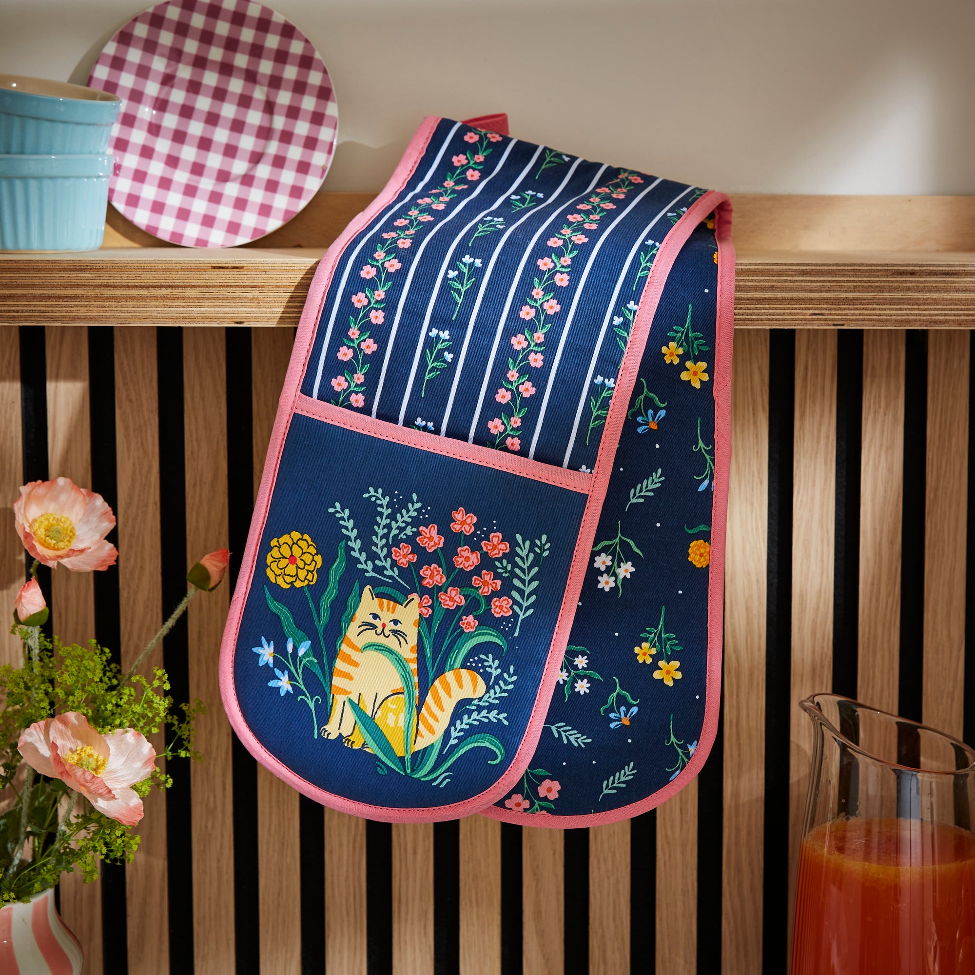 An Ulster Weavers Double Oven Mitt in the Marmalade Meadow pattern hangs over a kitchen countertop.