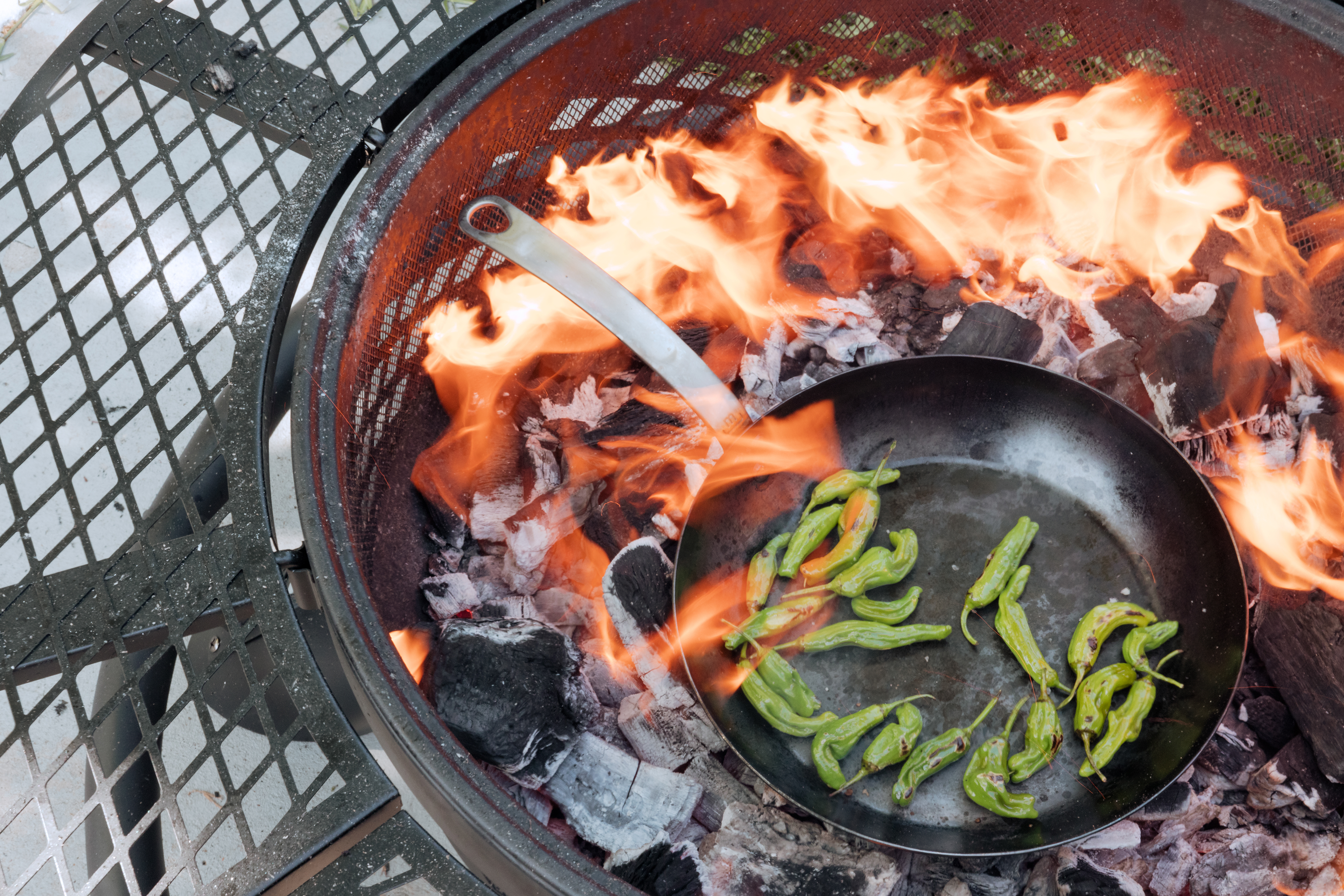 Pepperas are cooked in a Made In Seasoned Carbon Steel Fry Pan over in a fire pit.