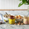 Gourmet ice cream bowls with caramel sauce and fudge on marble countertop