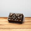 Bronze pumpkin-shaped baking pan on wooden table against a blue backdrop