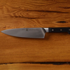 Chef's knife on wooden surface