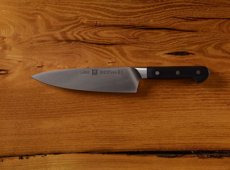 Chef's knife on wooden surface