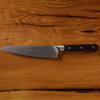 Chef's knife on a wooden table top