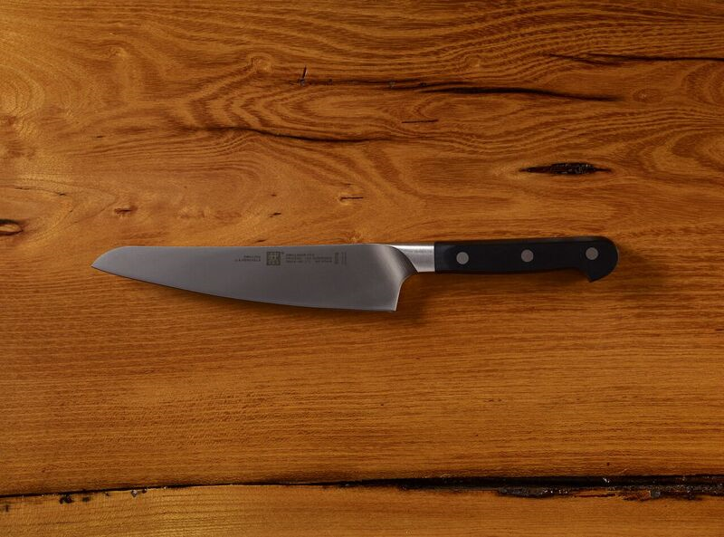 Chef's knife on a wooden table top