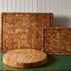 Round and rectangular wooden cutting boards on a vintage table