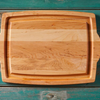 Wooden serving tray on turquoise wooden background