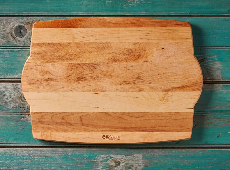 Wooden cutting board on a turquoise wooden table background