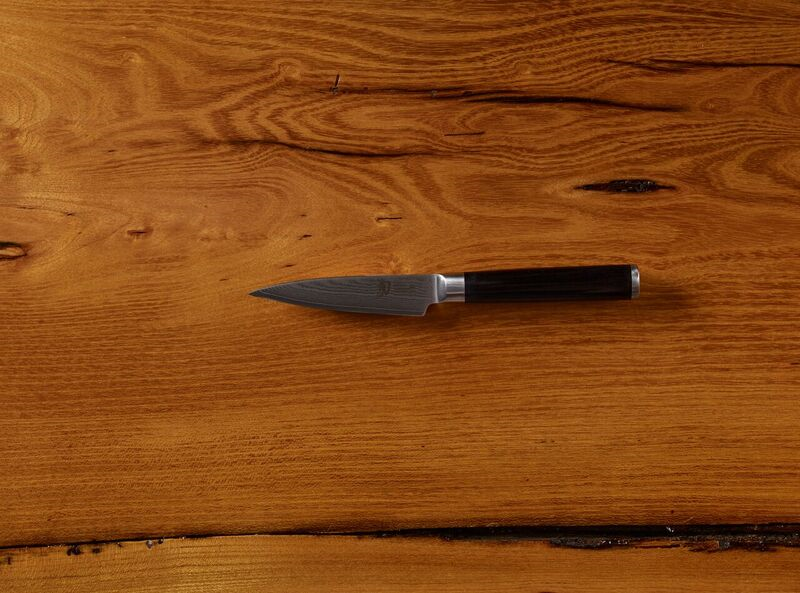 Chef knife on wooden cutting board top view
