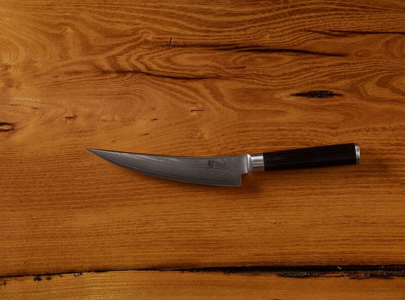Chef's knife on a wooden surface