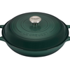 Green Le Creuset cast iron casserole dish with lid on white background
