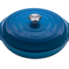 Blue cast iron Dutch oven with lid isolated on white background.