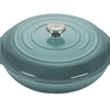 Green Le Creuset cast iron dutch oven on a white background